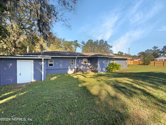 back of property featuring a lawn