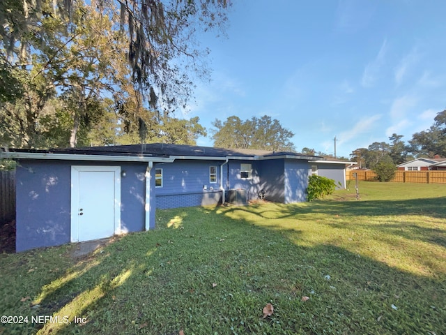 back of property featuring a lawn