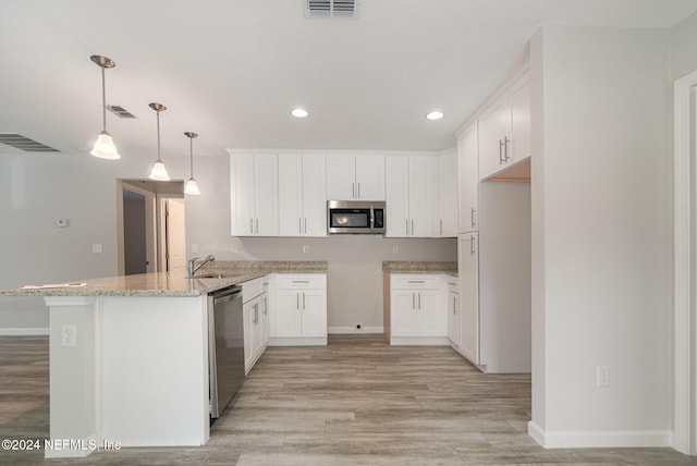 kitchen with white cabinetry, sink, stainless steel appliances, kitchen peninsula, and pendant lighting