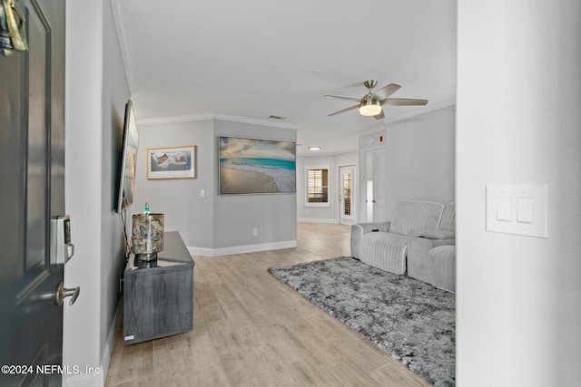 interior space featuring ceiling fan, light hardwood / wood-style flooring, and ornamental molding