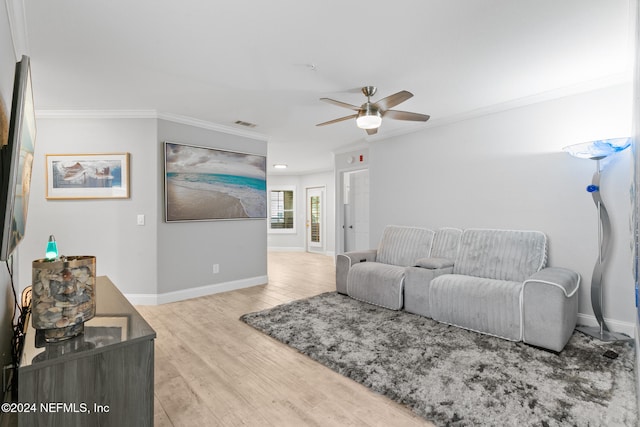 living room featuring hardwood / wood-style flooring, ceiling fan, and crown molding