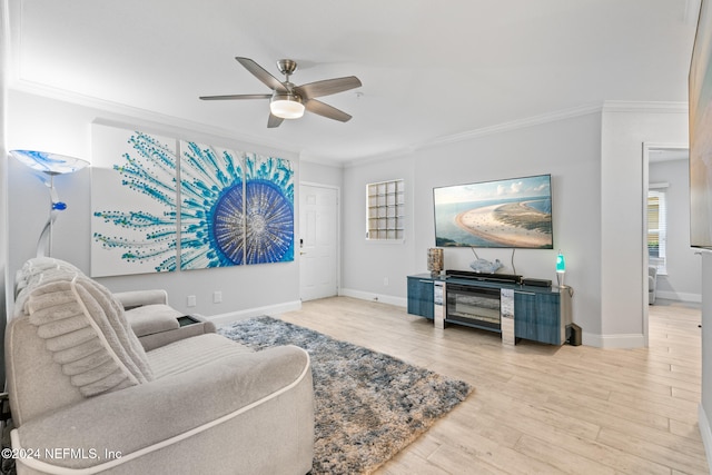 living room featuring hardwood / wood-style floors, ceiling fan, and crown molding