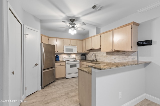 kitchen featuring kitchen peninsula, decorative backsplash, light stone countertops, white appliances, and light hardwood / wood-style flooring