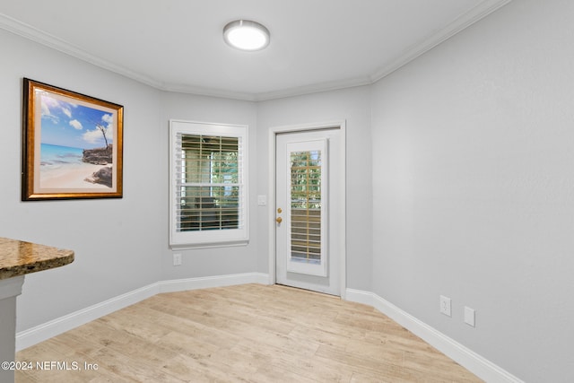 interior space featuring light hardwood / wood-style floors and ornamental molding