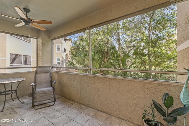 sunroom / solarium featuring ceiling fan