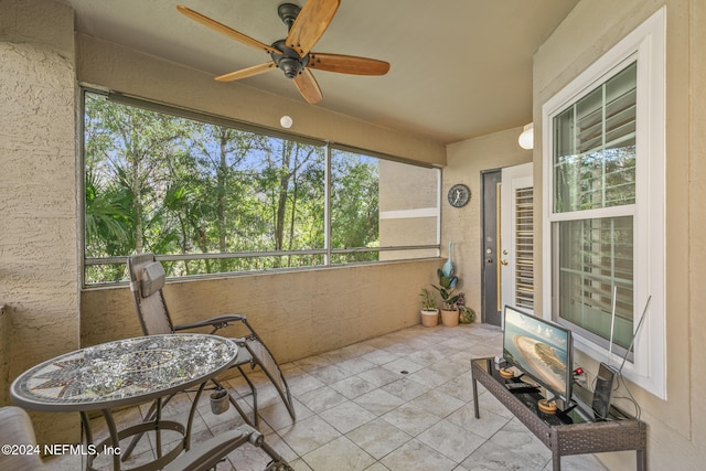 sunroom featuring ceiling fan and a healthy amount of sunlight