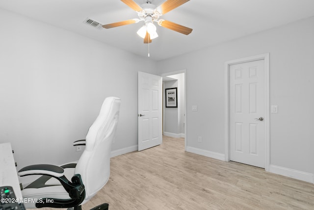 office space with light hardwood / wood-style floors and ceiling fan