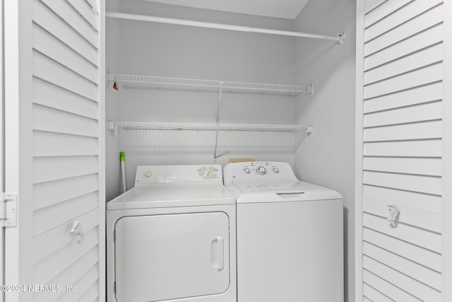 clothes washing area featuring separate washer and dryer