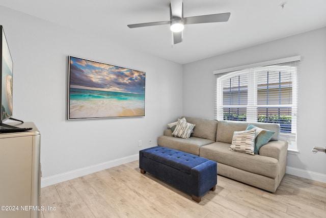 living room featuring light hardwood / wood-style flooring and ceiling fan