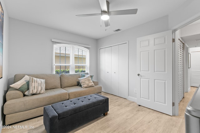 living room featuring ceiling fan and light hardwood / wood-style flooring