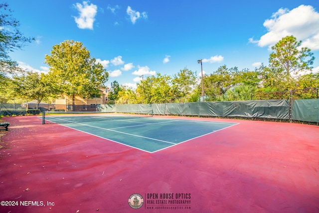 view of tennis court featuring basketball court