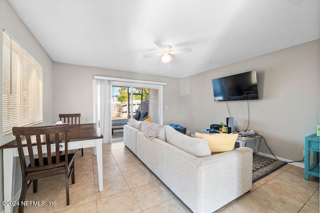 tiled living room featuring ceiling fan