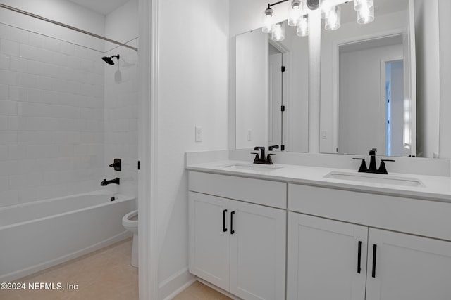 full bathroom featuring tile patterned flooring, tiled shower / bath combo, toilet, and vanity