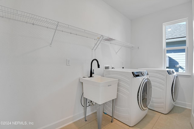 laundry area with light tile patterned floors and separate washer and dryer