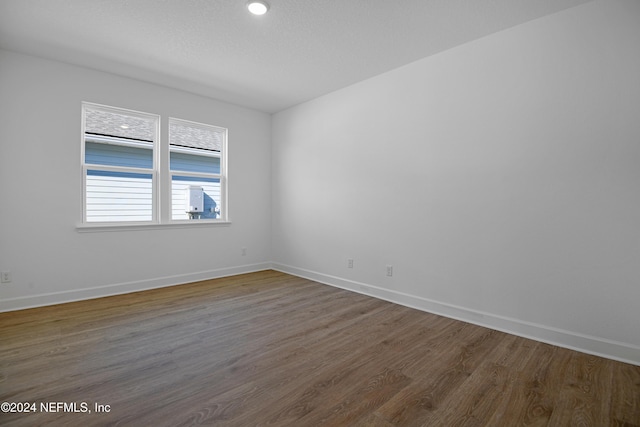 spare room featuring dark wood-type flooring