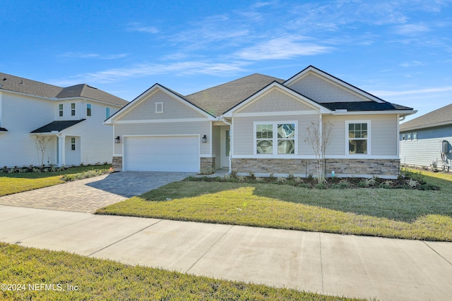 craftsman inspired home with a front yard and a garage