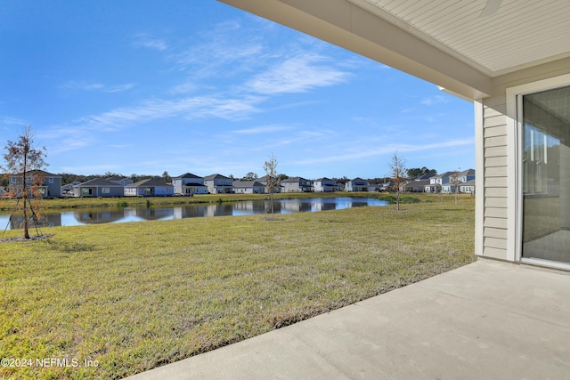 view of yard with a patio area and a water view