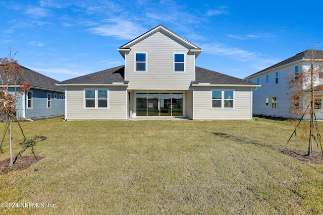 rear view of house with a yard