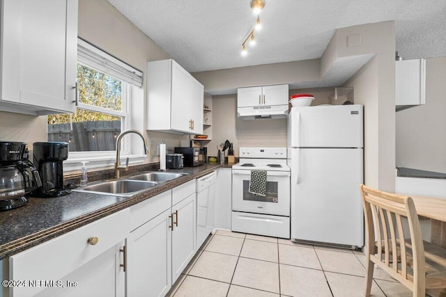 kitchen with a textured ceiling, white appliances, white cabinetry, and sink