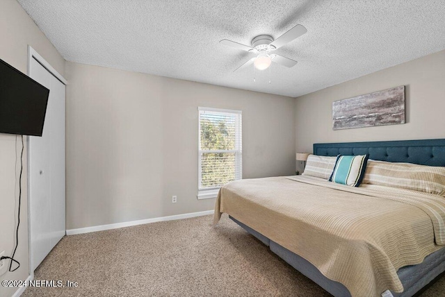 bedroom featuring carpet, ceiling fan, and a textured ceiling