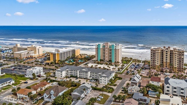 birds eye view of property with a beach view and a water view