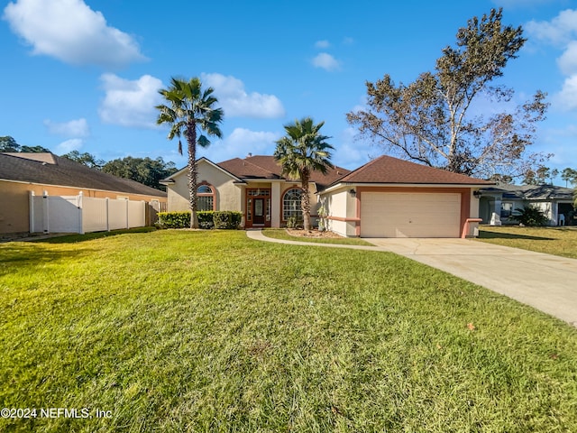 ranch-style house featuring a garage and a front lawn