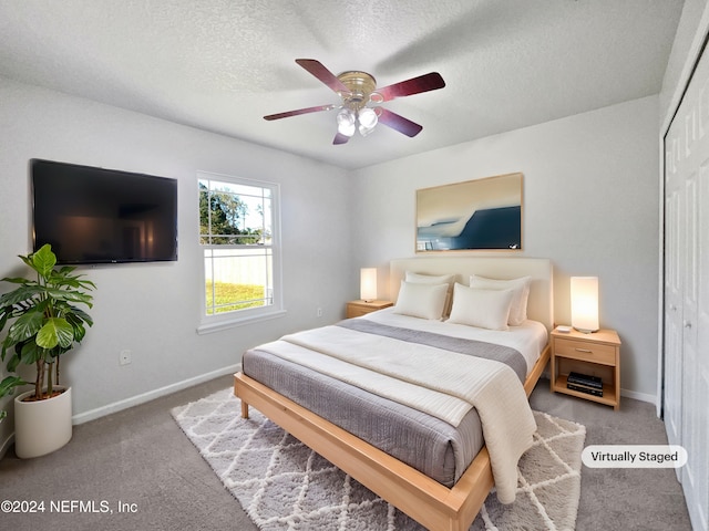 bedroom featuring carpet, a textured ceiling, a closet, and ceiling fan