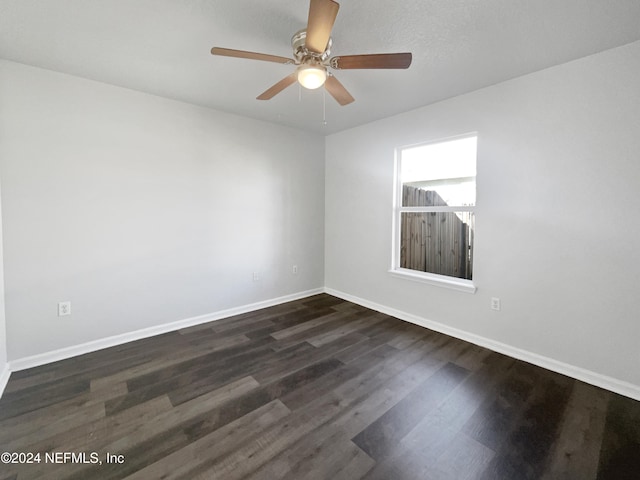 unfurnished room featuring ceiling fan and dark hardwood / wood-style flooring