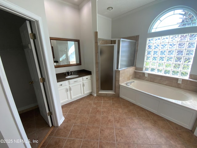 9767 Brockham Ct, Jacksonville, FL 32221 - bathroom featuring ornamental molding, vanity, a stall shower, tile patterned flooring, and a bath