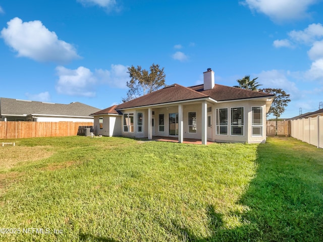 9767 Brockham Ct, Jacksonville, FL 32221 - rear view of house with a chimney, a patio area, stucco siding, and roof with shingles