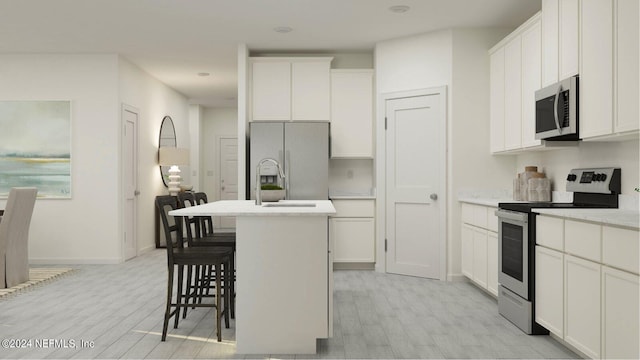 kitchen featuring white cabinetry, a center island with sink, and appliances with stainless steel finishes