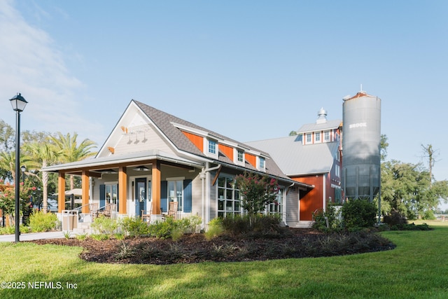 exterior space featuring covered porch and a front lawn