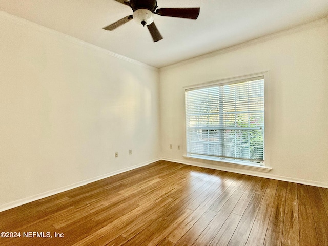 spare room featuring hardwood / wood-style flooring, ceiling fan, and ornamental molding