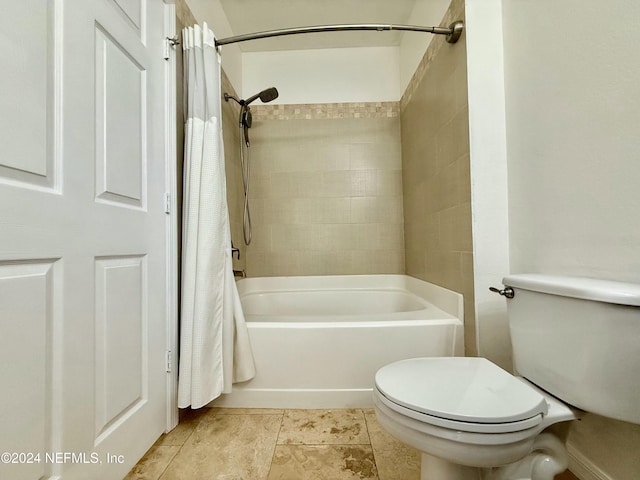 bathroom with shower / tub combo and toilet