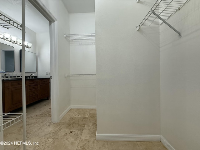 walk in closet featuring sink