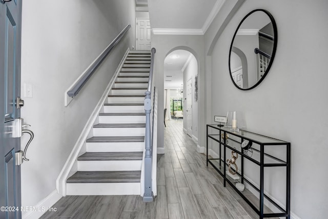 entrance foyer featuring light hardwood / wood-style floors and ornamental molding