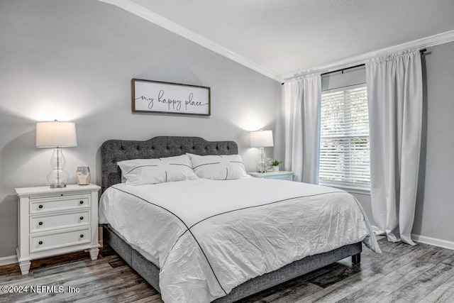 bedroom featuring wood-type flooring and ornamental molding