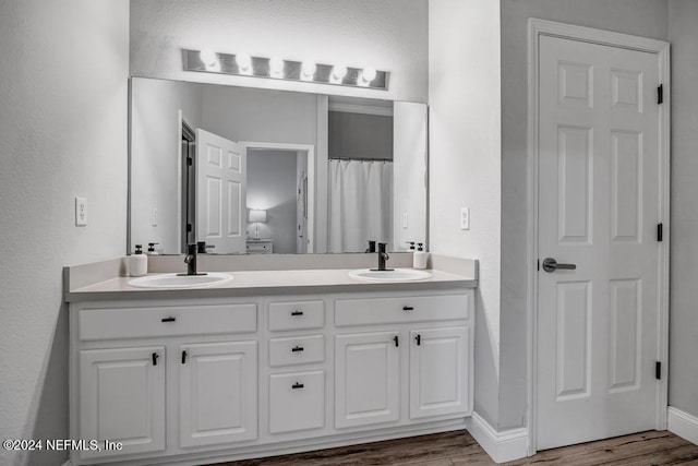 bathroom with vanity and wood-type flooring