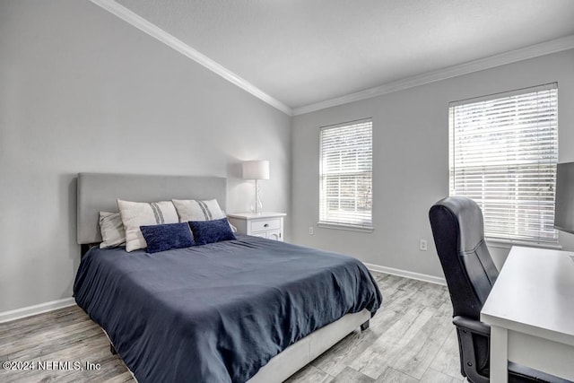 bedroom featuring multiple windows, light hardwood / wood-style floors, and ornamental molding