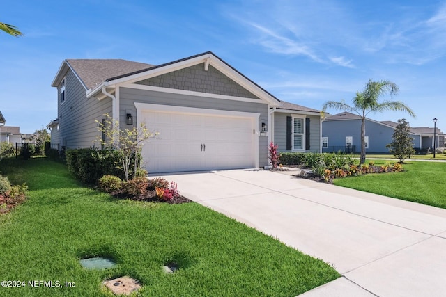 ranch-style house featuring a garage and a front yard