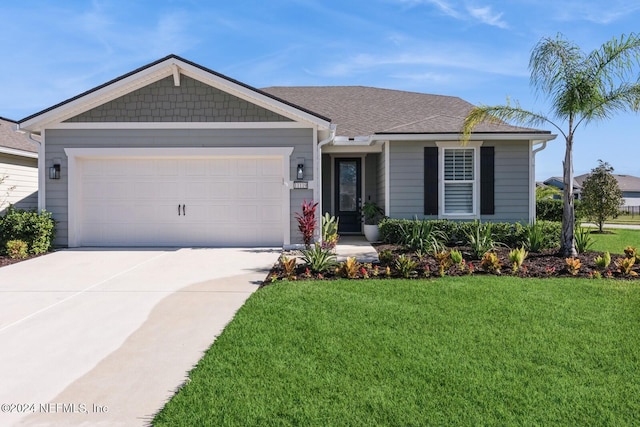 view of front facade with a front yard and a garage