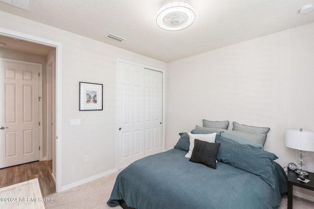 bedroom with carpet and a closet