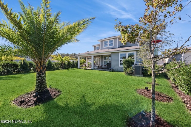 exterior space featuring a lawn and central AC unit