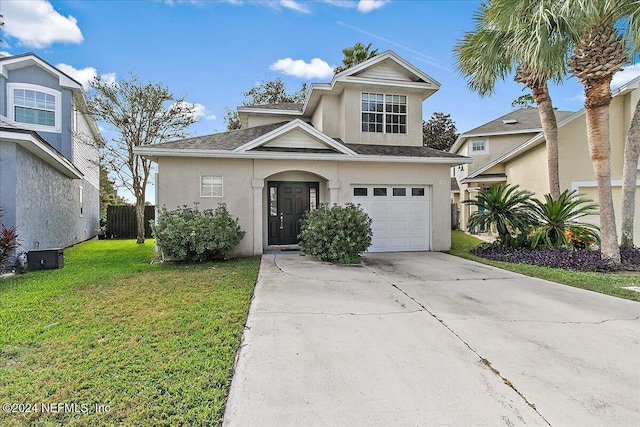 view of front property featuring a front yard and a garage