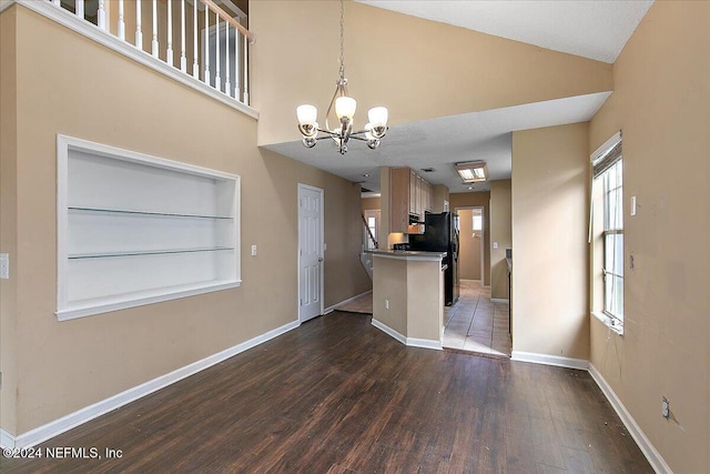 kitchen featuring a textured ceiling, dark hardwood / wood-style flooring, decorative light fixtures, and an inviting chandelier