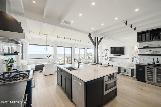 1304 Strand St, Neptune Beach, FL 32266 - kitchen with a sink, dark cabinetry, open floor plan, stainless steel appliances, and beamed ceiling