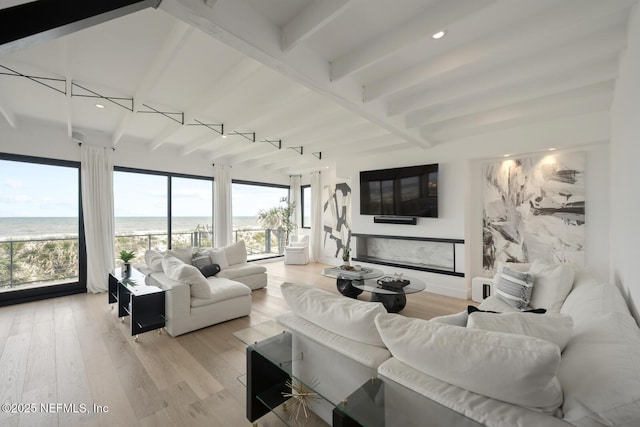 1304 Strand St, Neptune Beach, FL 32266 - living area featuring beamed ceiling, a water view, light wood-style flooring, and recessed lighting
