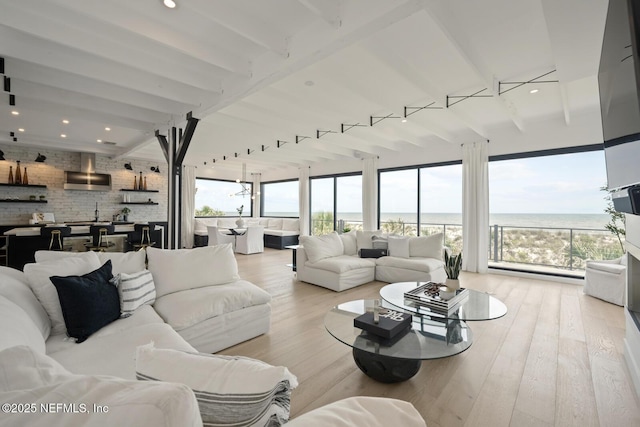 1304 Strand St, Neptune Beach, FL 32266 - living room featuring healthy amount of natural light, wood finished floors, a water view, and recessed lighting