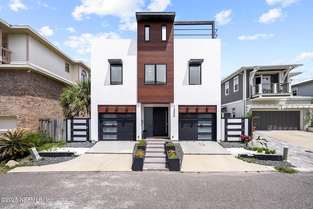 1304 Strand St, Neptune Beach, FL 32266 - contemporary house with stucco siding, an attached garage, and driveway