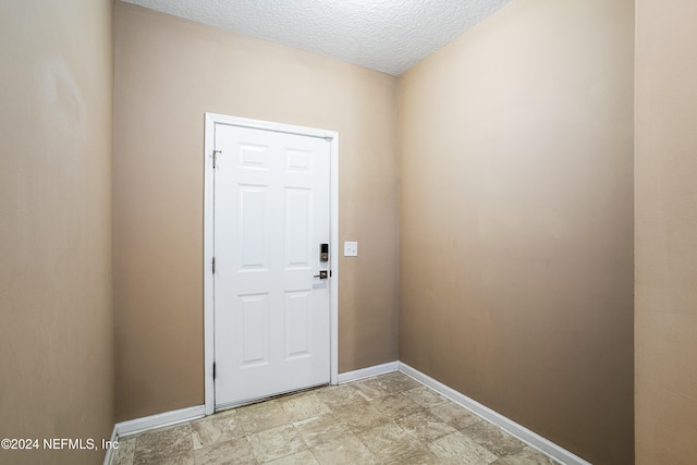 entryway featuring a textured ceiling